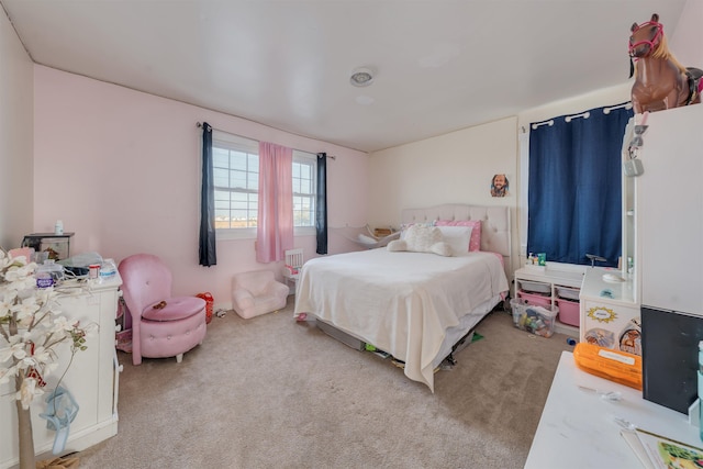 bedroom featuring light carpet