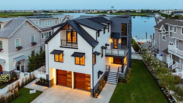 view of front of property with a water view and a garage