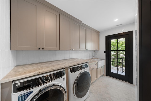 laundry room with cabinets, sink, light tile patterned floors, and washer and dryer