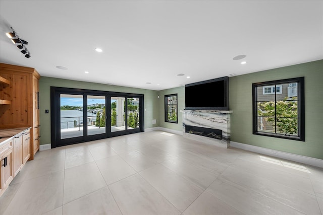 unfurnished living room with a fireplace and french doors