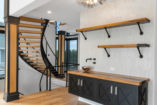 stairway with hardwood / wood-style flooring