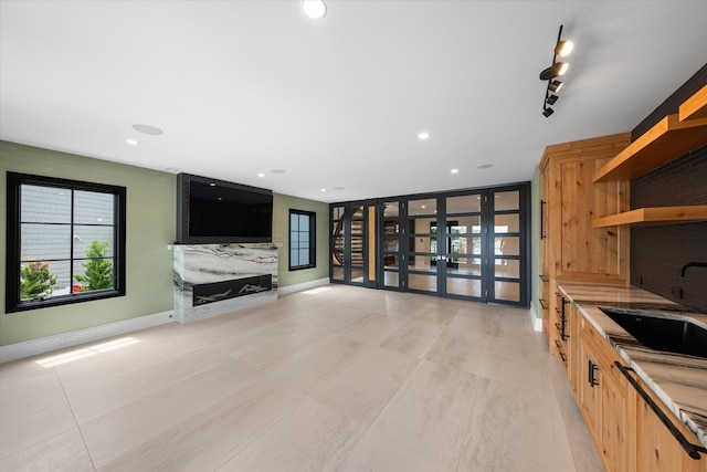 unfurnished living room with french doors and sink