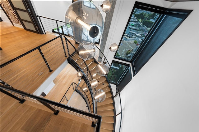 staircase with hardwood / wood-style floors