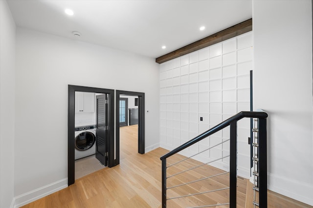 corridor featuring washer / dryer and hardwood / wood-style floors