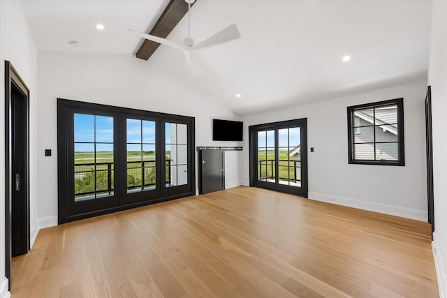 interior space featuring vaulted ceiling with beams, ceiling fan, and light wood-type flooring