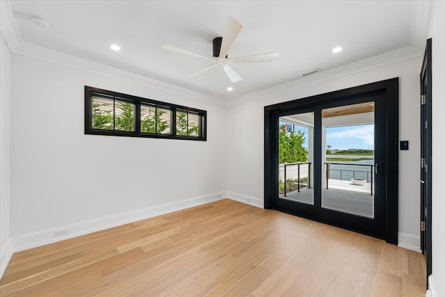 spare room featuring ceiling fan, light wood-type flooring, and ornamental molding