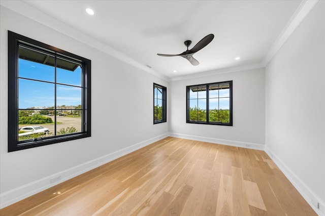 empty room with ceiling fan, light wood-type flooring, and crown molding