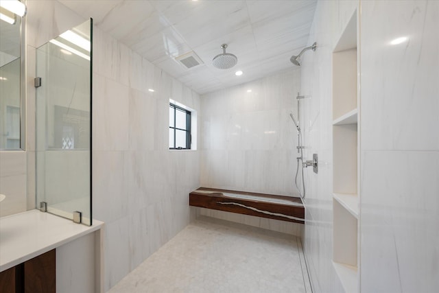 bathroom featuring tile walls and walk in shower