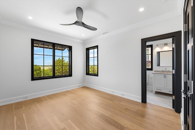 unfurnished room featuring ceiling fan, light hardwood / wood-style floors, sink, and crown molding