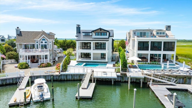 rear view of house featuring a patio and a water view