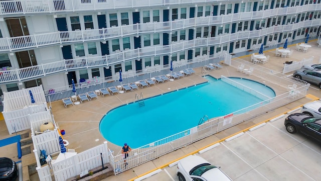 view of swimming pool featuring fence