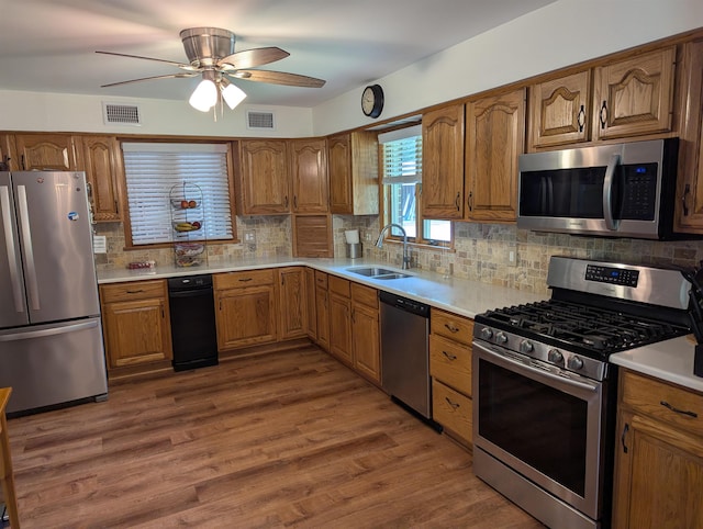 71 Perry Rd, Petersburg, NJ 08270 - kitchen with appliances with stainless steel finishes, brown cabinetry, a ceiling fan, and tasteful backsplash