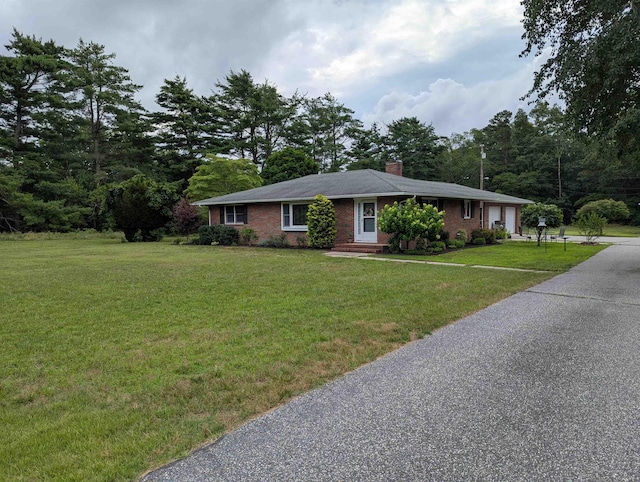 71 Perry Rd, Petersburg, NJ 08270 - ranch-style home featuring a front lawn, brick siding, a chimney, a garage, and driveway