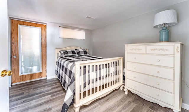 bedroom with hardwood / wood-style floors