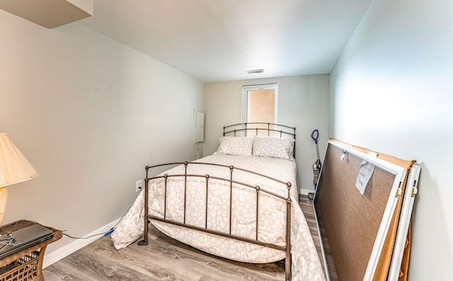 bedroom with wood-type flooring