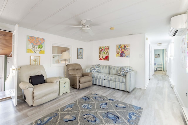 living room featuring light hardwood / wood-style flooring, an AC wall unit, and ceiling fan