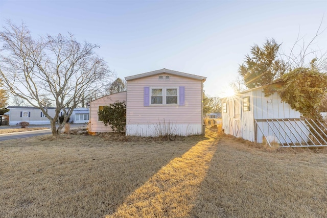 view of side of property featuring a yard