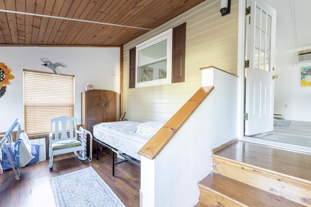 interior space featuring dark wood-type flooring, wood walls, wood ceiling, a wall mounted AC, and a baseboard radiator