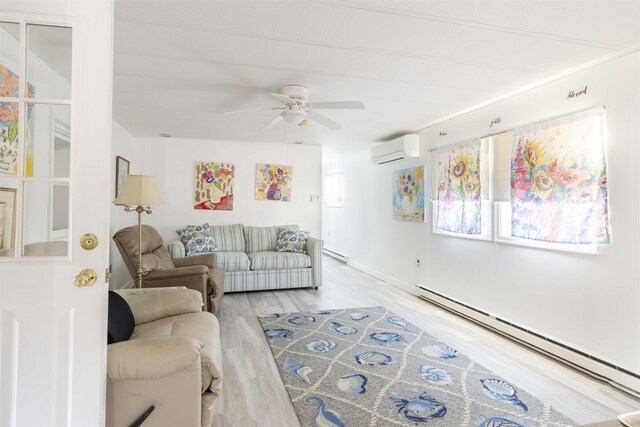 living room with a baseboard heating unit, a wall mounted air conditioner, ceiling fan, and light hardwood / wood-style flooring