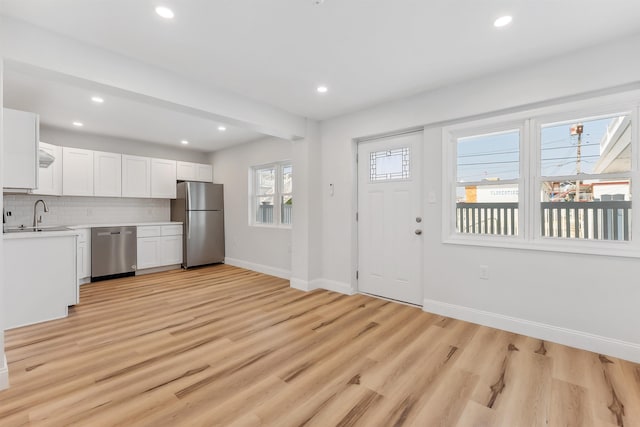 2001 Surf Ave Unit 2, North Wildwood, NJ 08260 - kitchen featuring appliances with stainless steel finishes, a sink, baseboards, light countertops, and white cabinetry