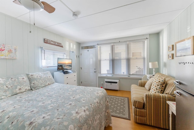 1800 Atlantic Ave Unit 103, North Wildwood, NJ 08260 - bedroom featuring light wood-type flooring, a wall mounted air conditioner, and a ceiling fan