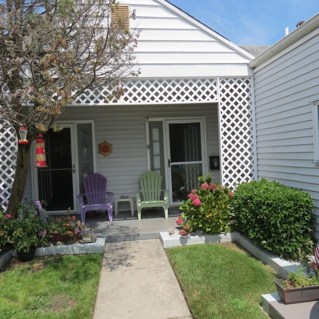 view of exterior entry with covered porch