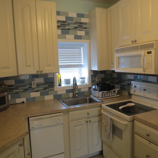 kitchen with decorative backsplash, white appliances, white cabinetry, and sink