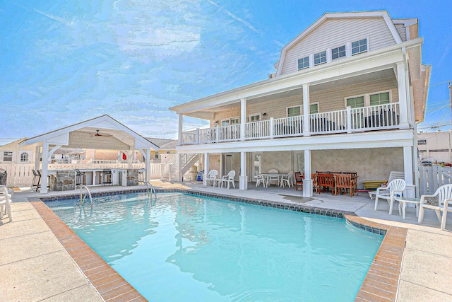 view of pool with a patio, exterior bar, fence, and a fenced in pool