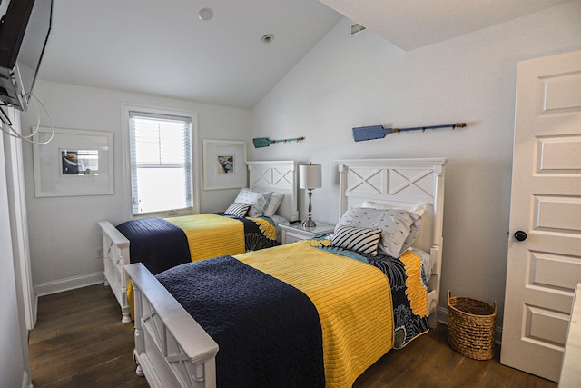 bedroom with vaulted ceiling, dark wood finished floors, and baseboards