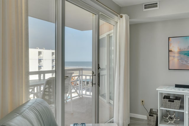 doorway to outside featuring visible vents, baseboards, and a water view