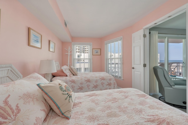 bedroom with visible vents and access to outside
