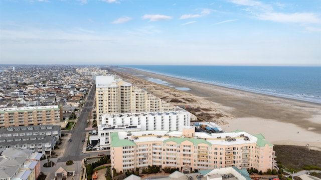 drone / aerial view featuring a beach view and a water view