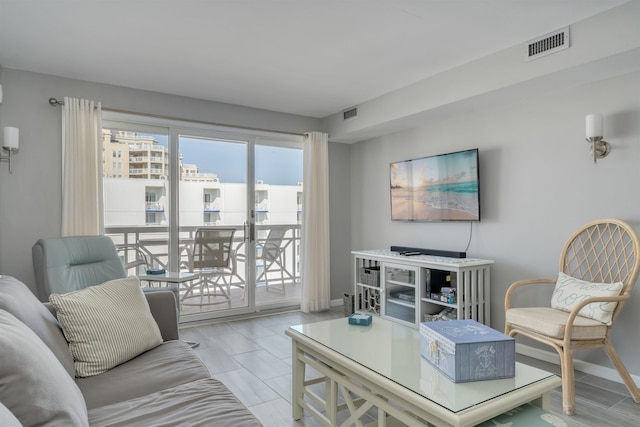 living room featuring baseboards and visible vents