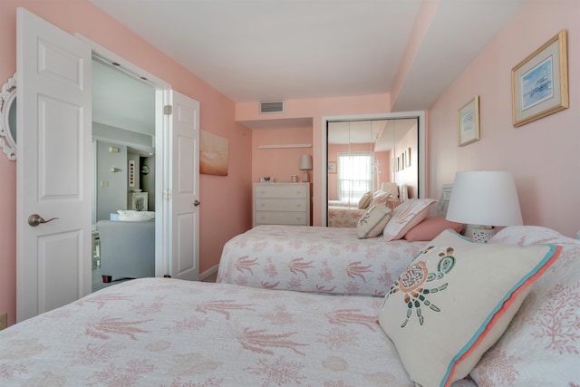 bedroom with visible vents and a closet