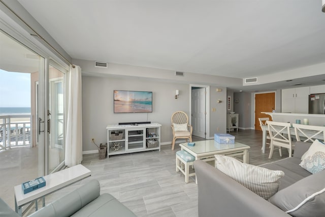 living room featuring baseboards and visible vents