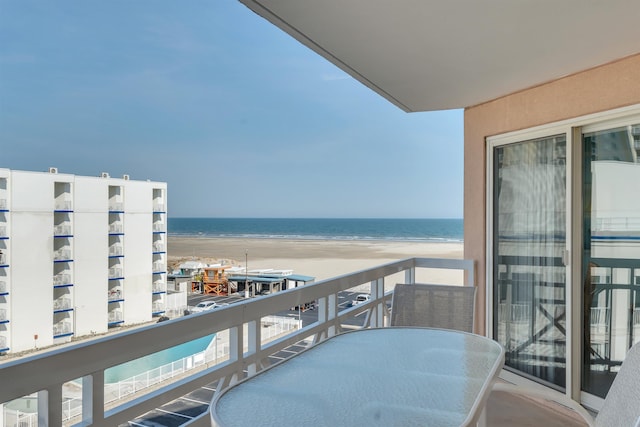 balcony with a view of the beach and a water view