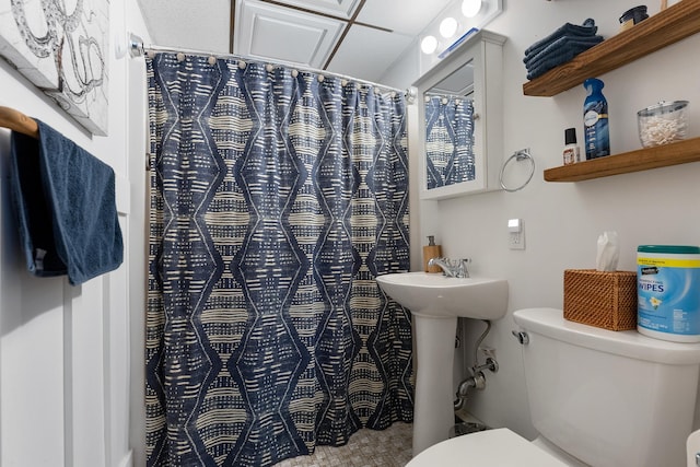 bathroom with a shower with curtain and toilet