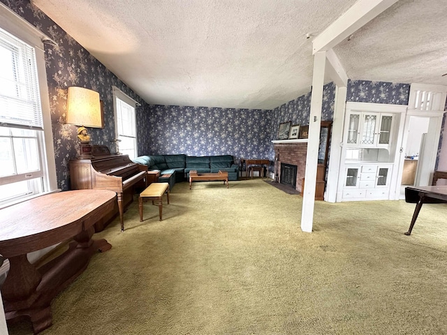 1083 Seashore Rd, Cold Spring, NJ 08204 - living room featuring wallpapered walls, a textured ceiling, carpet, and a brick fireplace