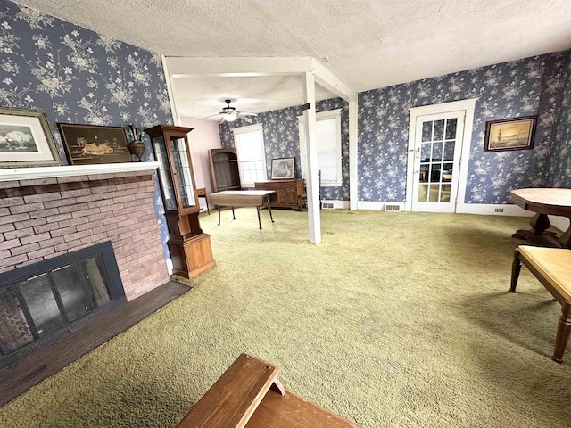 1083 Seashore Rd, Cold Spring, NJ 08204 - living room featuring wallpapered walls, carpet floors, a textured ceiling, a fireplace, and a ceiling fan