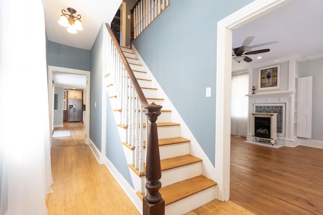 837 Seashore Rd, Lower Township, NJ 08204 - stairs featuring baseboards, a ceiling fan, wood finished floors, and a premium fireplace