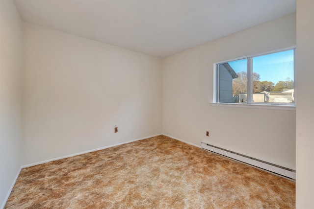 carpeted spare room featuring a baseboard heating unit