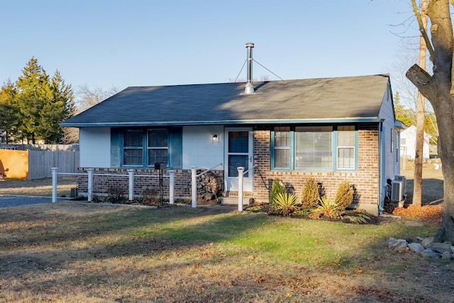 view of front of house featuring a front lawn and central air condition unit