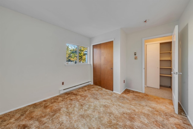 unfurnished bedroom with a closet, light colored carpet, and a baseboard radiator