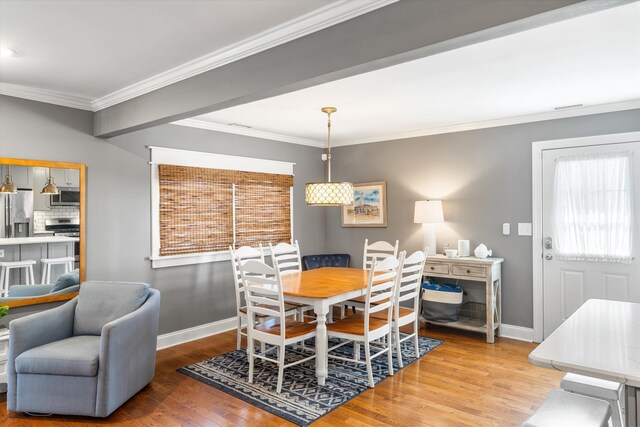 630 21st St Fl 2Nd, Avalon, NJ 08202 - dining area with wood finished floors, crown molding, and healthy amount of natural light
