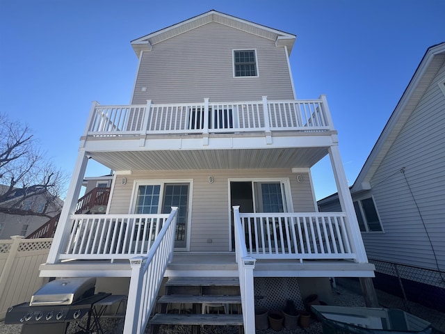 rear view of house featuring a balcony