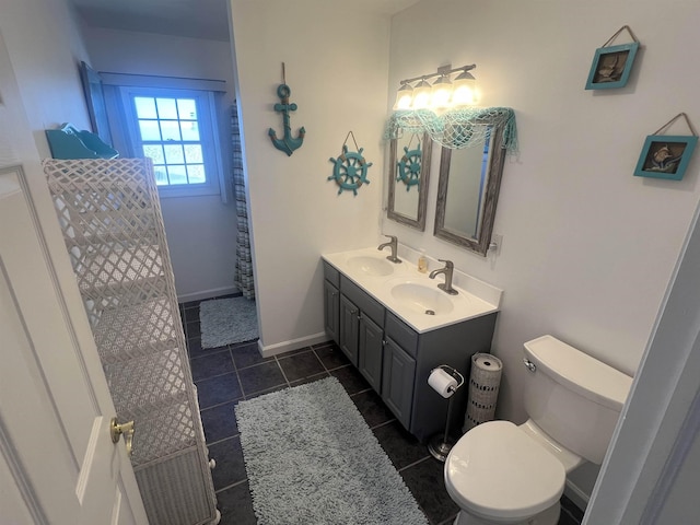 bathroom featuring vanity, tile patterned floors, and toilet