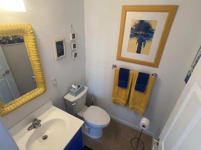 bathroom with tile patterned flooring, vanity, and toilet