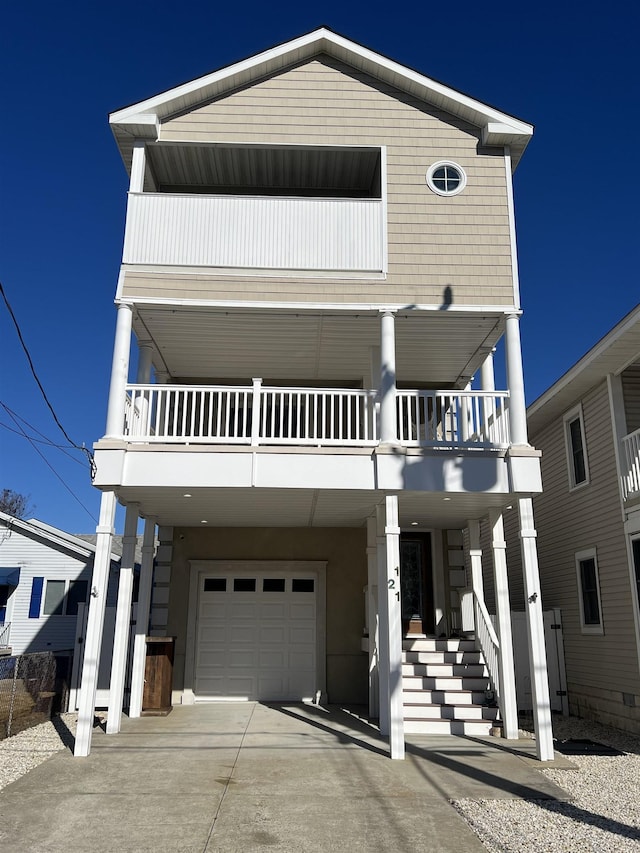 view of front facade featuring a garage and a balcony