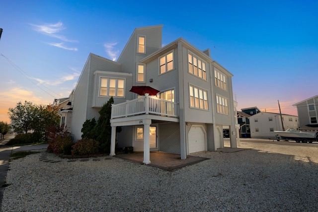 exterior space with a balcony and a garage