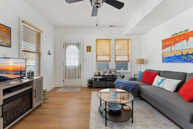 living room featuring ceiling fan and light hardwood / wood-style flooring